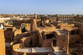 A scenic view of Ushaiger Oasis, showcasing lush greenery surrounded by desert landscape