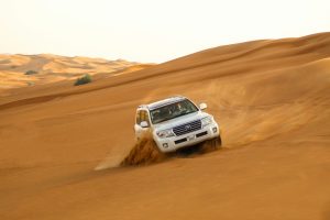 "Illustration showcasing a desert safari adventure with a 4x4 vehicle dune bashing, camel riding, and traditional Emirati hospitality in Dubai.