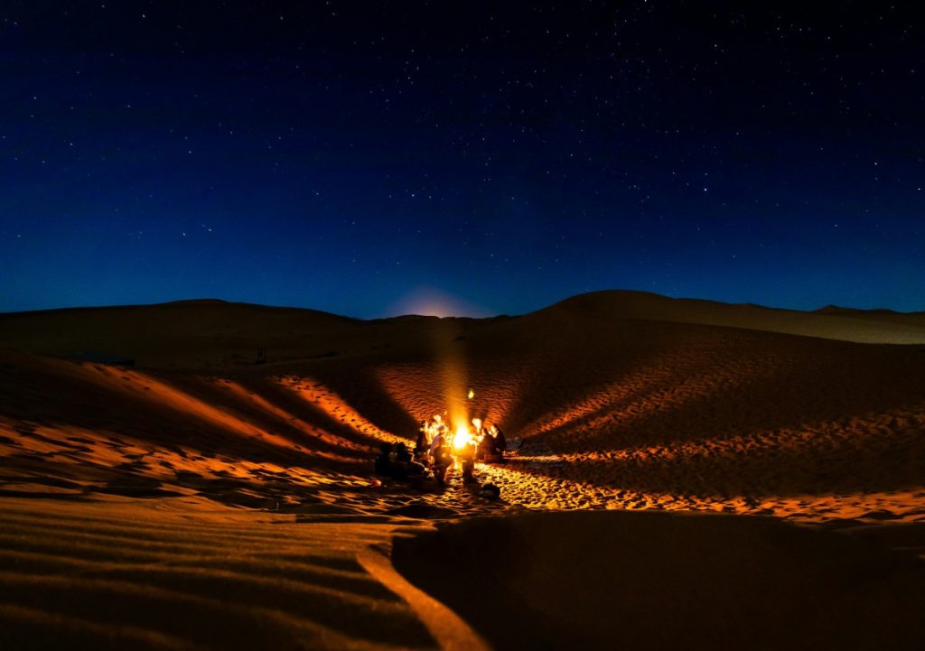 Silhouettes against starry sky in the Arabian Desert