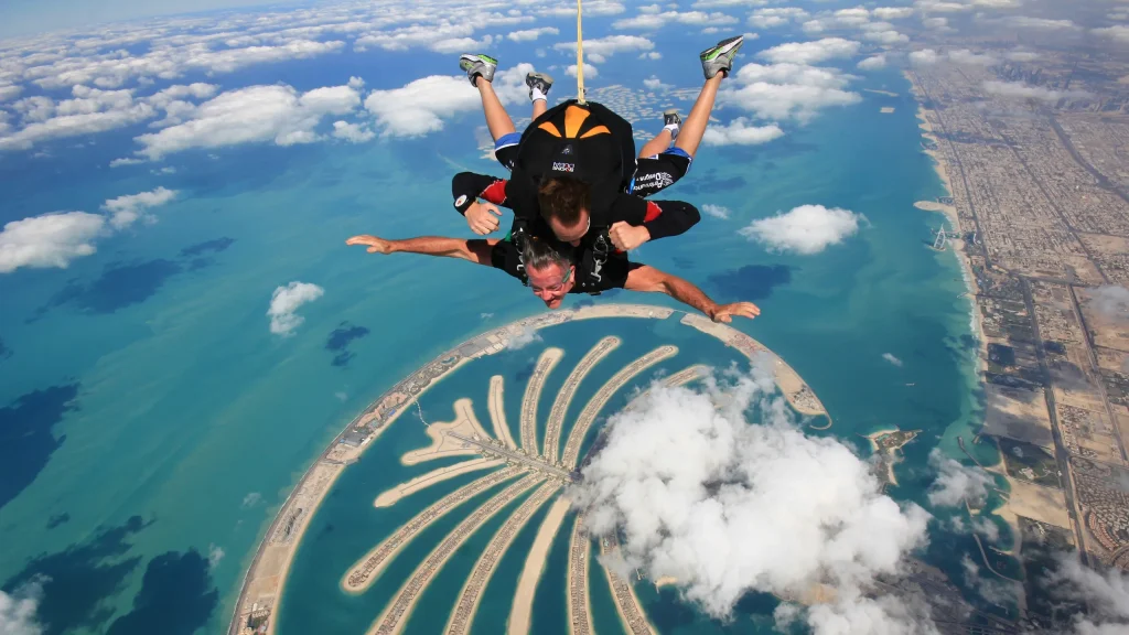 Soaring skydiver against city skyline.