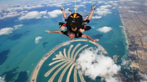 Soaring skydiver against city skyline.